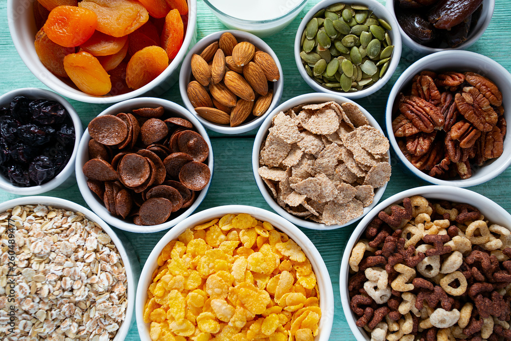 various cereals, nuts and dried fruits on wooden surface various cereals, nuts and dried fruits on wooden surface