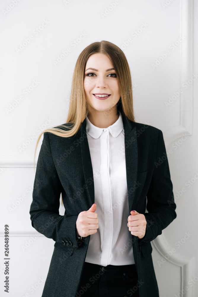 Portrait of a beautiful young stylish businesswoman in a suit on a white background. Portrait of a beautiful young stylish businesswoman in a suit on a white background.