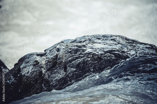 Mountain water washes stone in the river