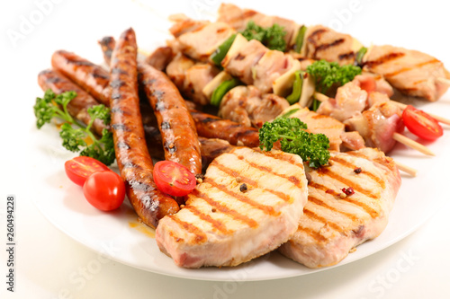 assorted barbecue meat with sausage, pork chop and beef skewer