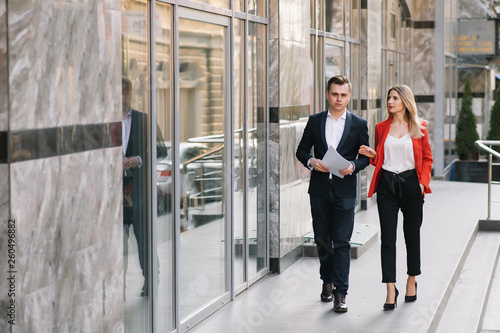 Young business people walking together along the street