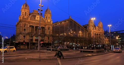 BUDAPEST, HUNGARY - JANUARY 17, 2019 : A night view of main facade of The Nyugati Train Station In Budapest. City traffic time lapse photo