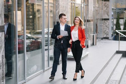 Handsome man in suit is looking at his watch attentively. He is waiting for his business partner. Look Exquisitely Stylish.