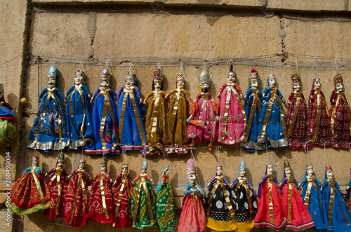 Colorful Kathputli or Puppets displayed on the wall, near Patwon Ki Haveli, Jaisalmer, Rajasthan, India.