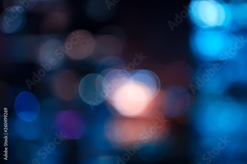 blurred bokeh city background / glare and glowing light in night city, modern beautiful bright background