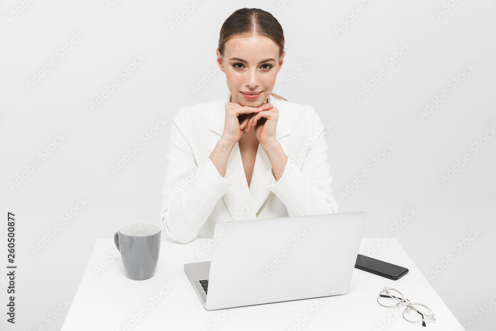 Happy amazing woman posing isolated over white wall background using laptop computer. Happy amazing woman posing isolated over white wall background using laptop computer.
