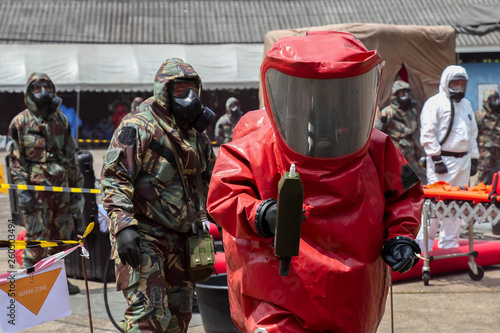 they are in protective gear cleaning up after chemical or radiation accident and radiation sefety.