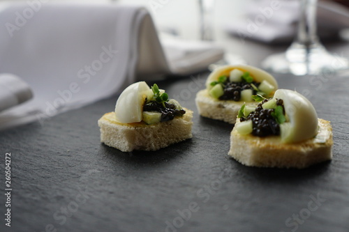 black caviar served on canape with boiled egg 
