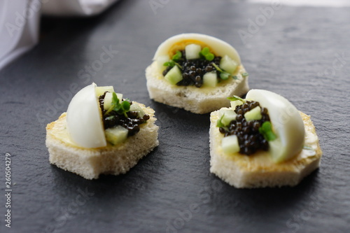 black caviar served on canapes with boiled egg 