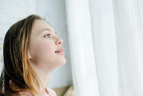 Inspired cute teenage child looking away with open mouth