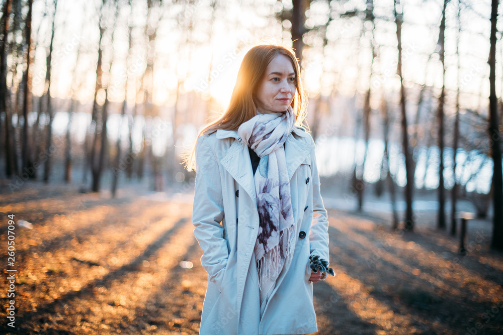 Portrait of a girl on the background of trees in early spring at sunset. Portrait of a girl on the background of trees in early spring at sunset.