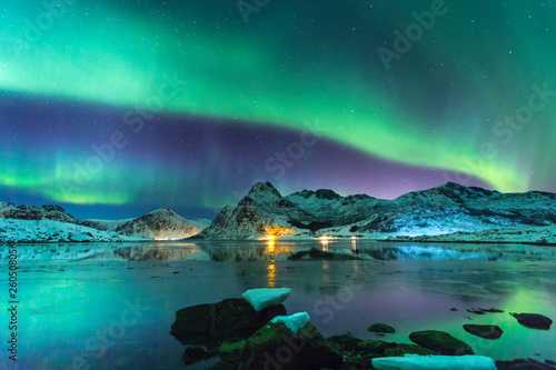 Northern lights at night against the backdrop of beautiful mountains and glaciers photo