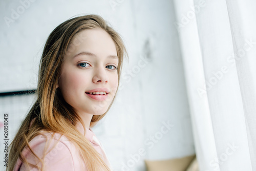 Joyful teenage kid in pink hoodie looking at camera with smile Free Download Joyful teenage kid in pink hoodie looking at camera with smile - GFXLoad