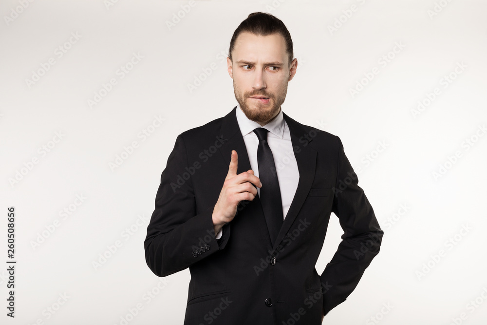 Happy beautiful bearded guy with good-looking hairstyle, wearing black suit and tie Happy beautiful bearded guy with good-looking hairstyle, wearing black suit and tie