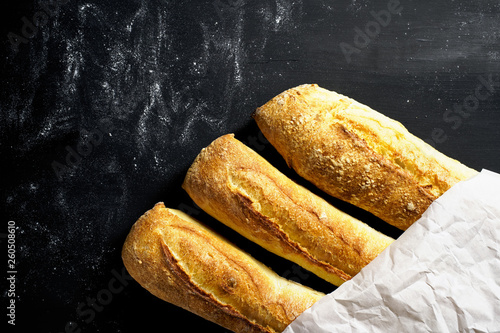 Three baguettes in the package on a black background