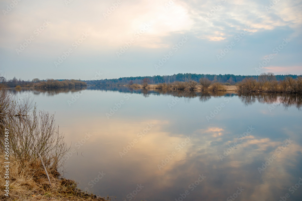 Morning sunrise and sky reflection on the surface of the river