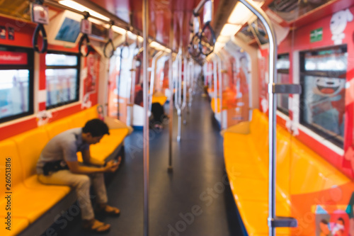 Blurred picture of people sitting in Thailand Sky Train. Transport concept.