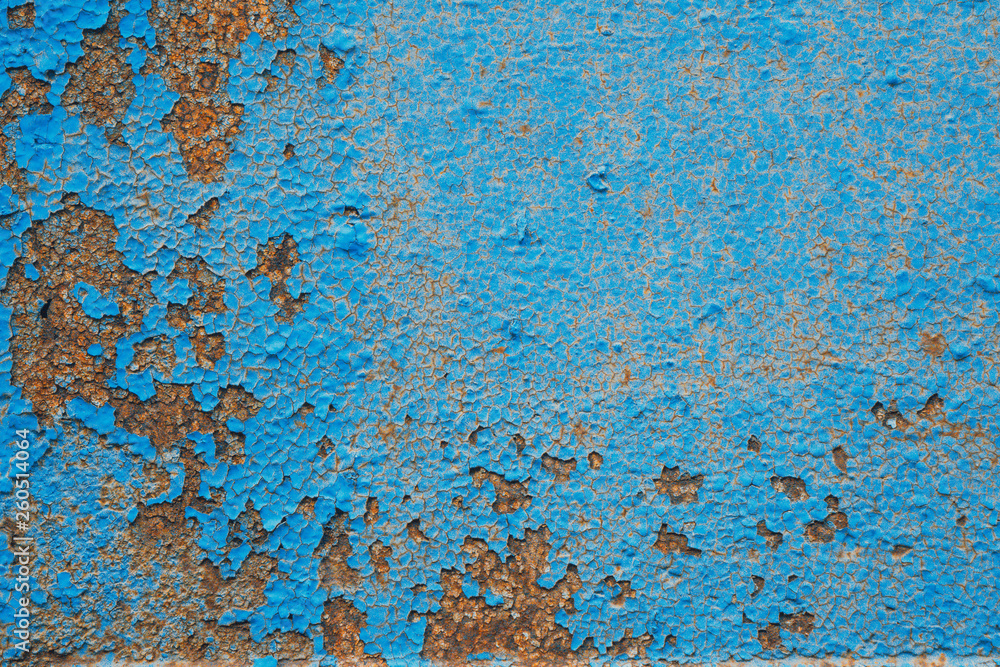 Old Painted Blue Wall. Background. Cracked Flaked Shabby Wall With Rundown Stucco Layer Texture. Old Painted Blue Wall. Background. Cracked Flaked Shabby Wall With Rundown Stucco Layer Texture.
