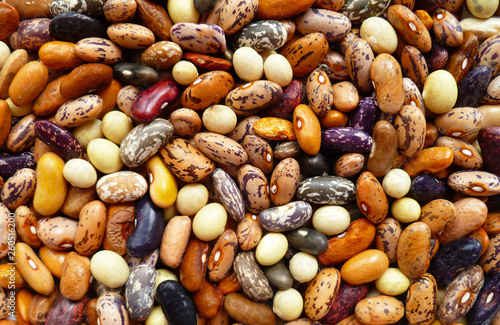 Bean mix for backgrounds or textures. Assorted dried beans close up. Variety of protein rich colorful raw dried beans. Multicolored mixed dried beans on a white background.