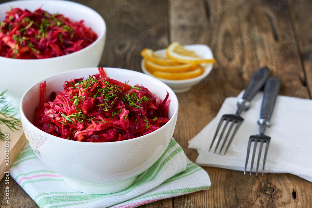 Vegetable salad with beets, cabbage and carrots in a white bowl Vegetable salad with beets, cabbage and carrots in a white bowl