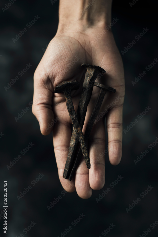 rusty nails on the hand of a man