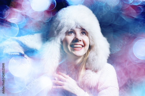 Fototapeta Naklejka Na Ścianę i Meble -  model in winter hat / beautiful adult girl in a big fur hat, winter clothes, Christmas holiday
