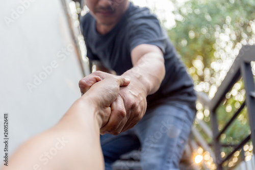 Man saving other by griping the forearm rescuing and helping concept.