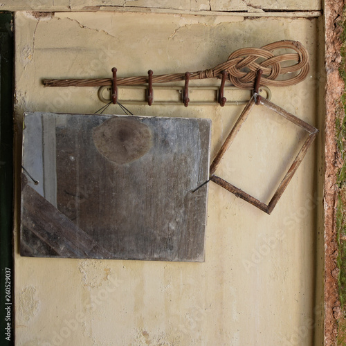 hanger with rusty mirror and broken frame photo