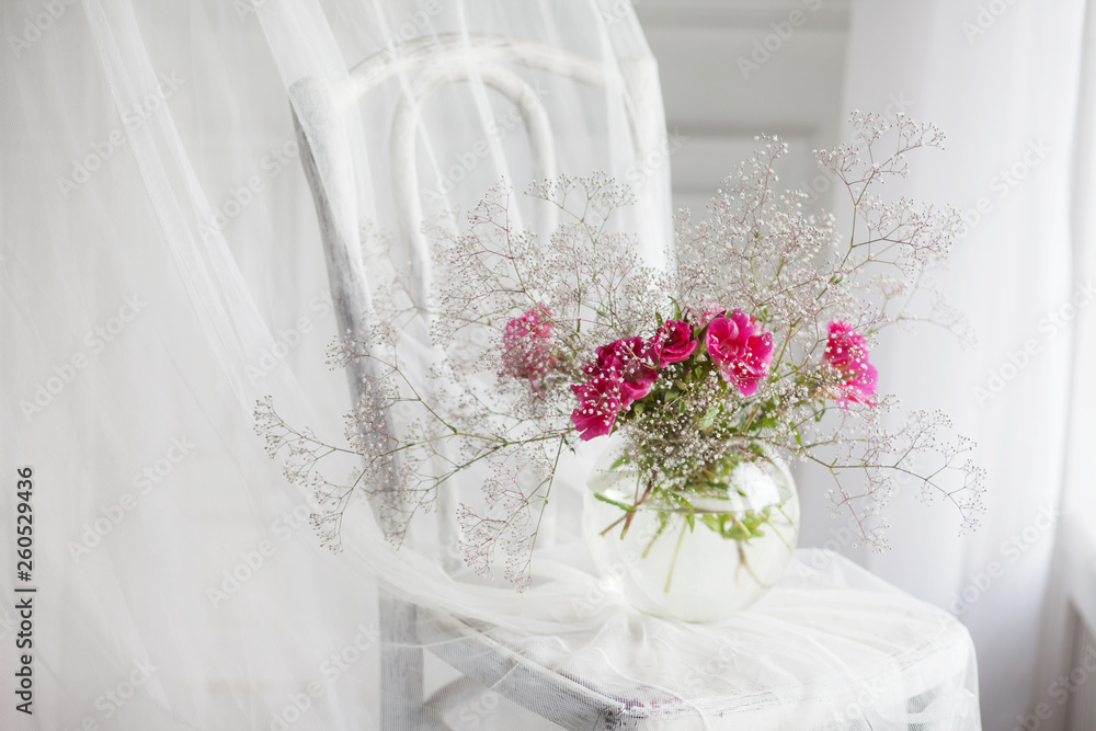 Still life with gipsofila and rose flowers in glass vase on retro chair  Stock Photo | Adobe Stock