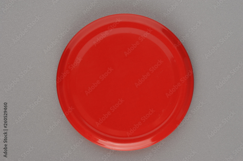 Screw cap for glass jars. For canning, canned food. Red cap on gray background Screw cap for glass jars. For canning, canned food. Red cap on gray background