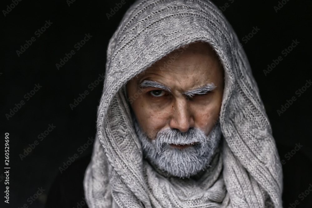 make-up man with a beard / concept oriental portrait in traditional dress, gray-haired white beard in an Arab man make-up man with a beard / concept oriental portrait in traditional dress, gray-haired white beard in an Arab man