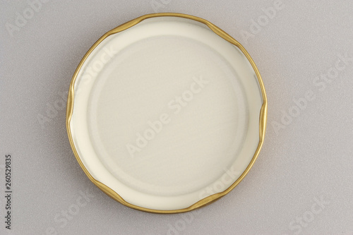 Screw cap for glass jars. For canning, canned food. Golden cap on gray background flip cover