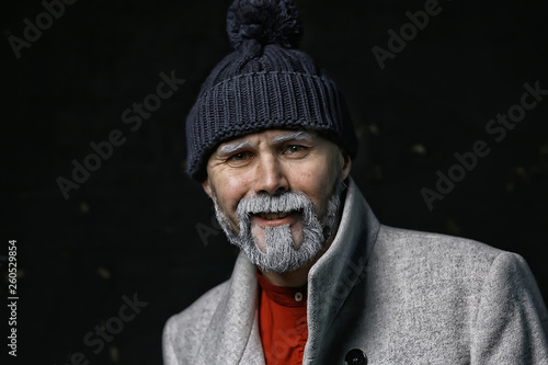 Santa Claus hipster / portrait of a fashionable modern Santa, young man with a gray beard, Christmas winter portrait