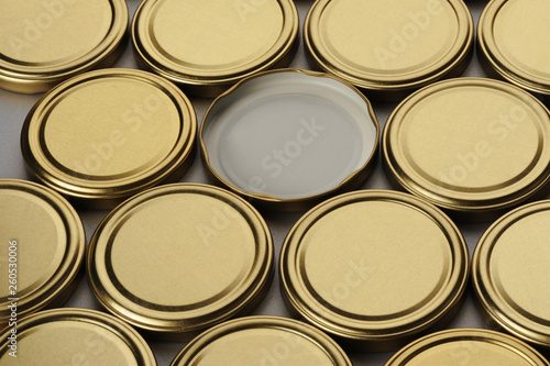 Screw caps for glass jars. For canning, canned food. Golden caps on gray background