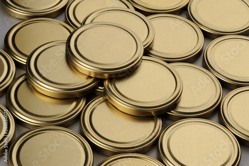 Screw caps for glass jars. For canning, canned food. Golden caps on gray background