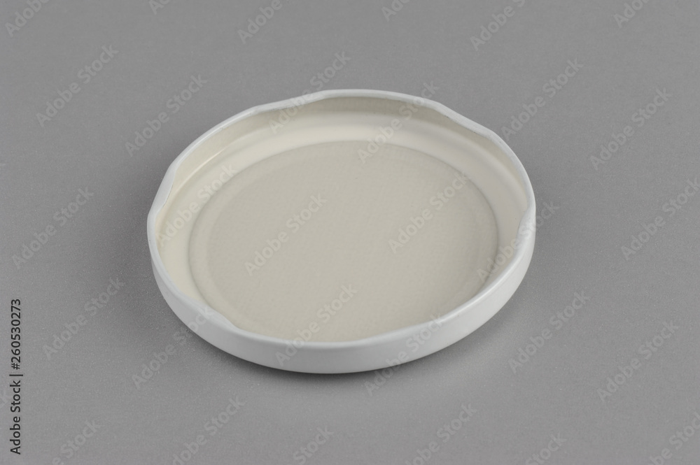 Screw cap for glass jars. For canning, canned food. White cap on gray background flip covers Screw cap for glass jars. For canning, canned food. White cap on gray background flip covers