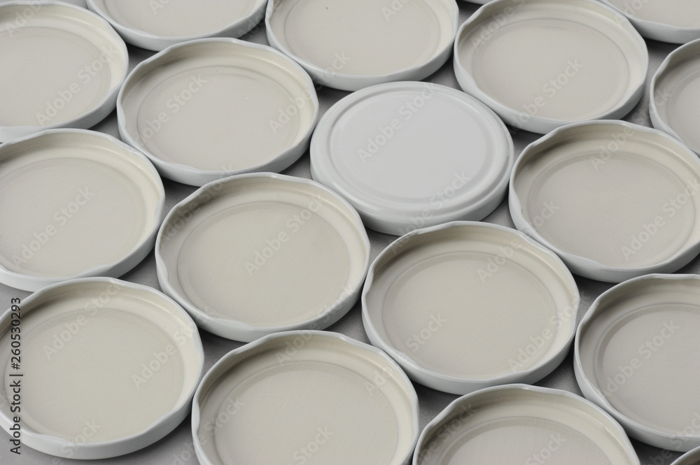 Screw caps for glass jars. For canning, canned food. White caps on gray background Screw caps for glass jars. For canning, canned food. White caps on gray background