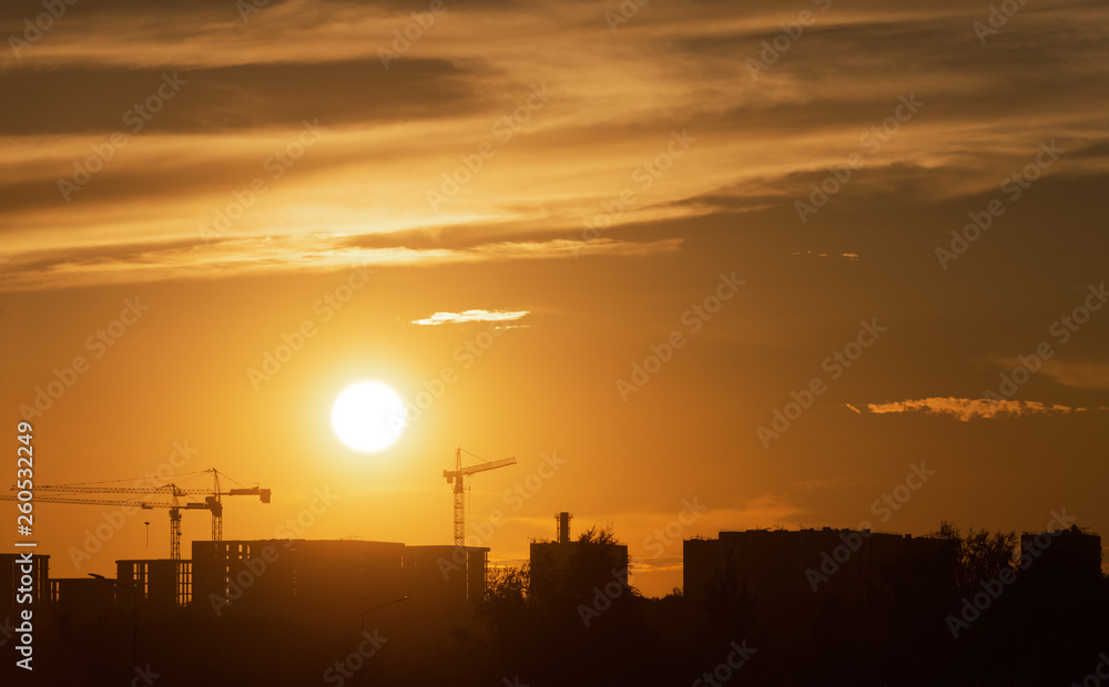 Construction. Construction cranes at sunset. Construction of residential buildings in Moscow.