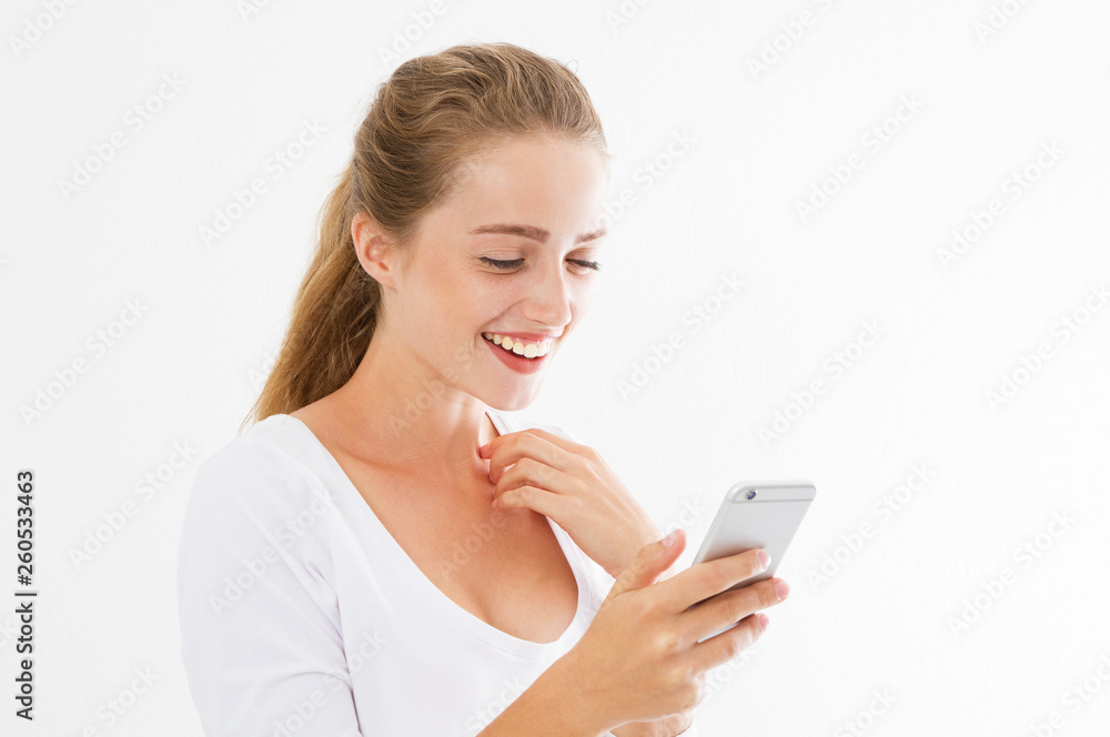Good news phone. Excited happy girl reading good news on smart phone standing in white transparent background. Young beautiful smile woman and phone. Good news phone. Excited happy girl reading good news on smart phone standing in white transparent background. Young beautiful smile woman and phone.