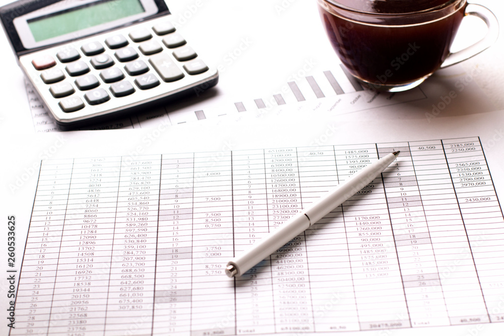 Accountant work table with calculator, charts and pen. Accountant work table with calculator, charts and pen.