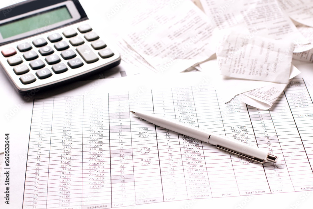 Accountant work table with calculator, charts and pen. Accountant work table with calculator, charts and pen.