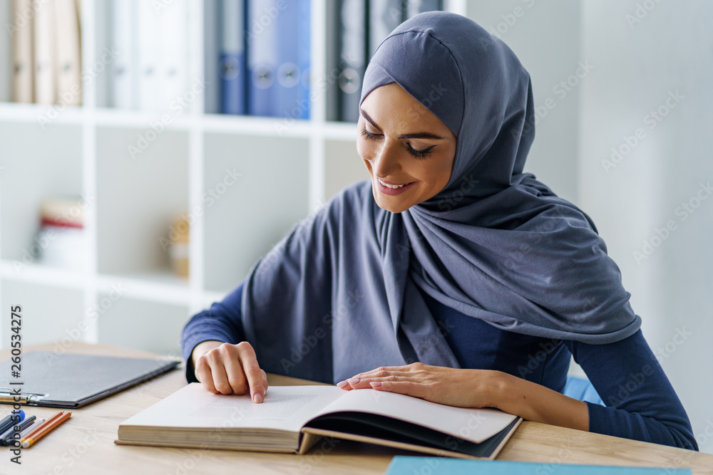 Beautiful Muslim woman reading Beautiful Muslim woman reading