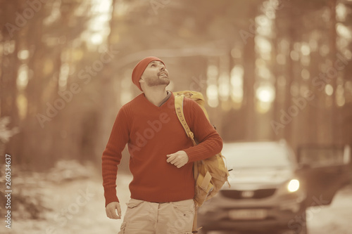 winter landscape forest backpack man / traveler in modern winter clothes in the forest, traveling in the mountains europe, switzerland winter