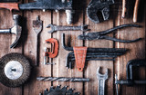 grungy old tools on a wooden background