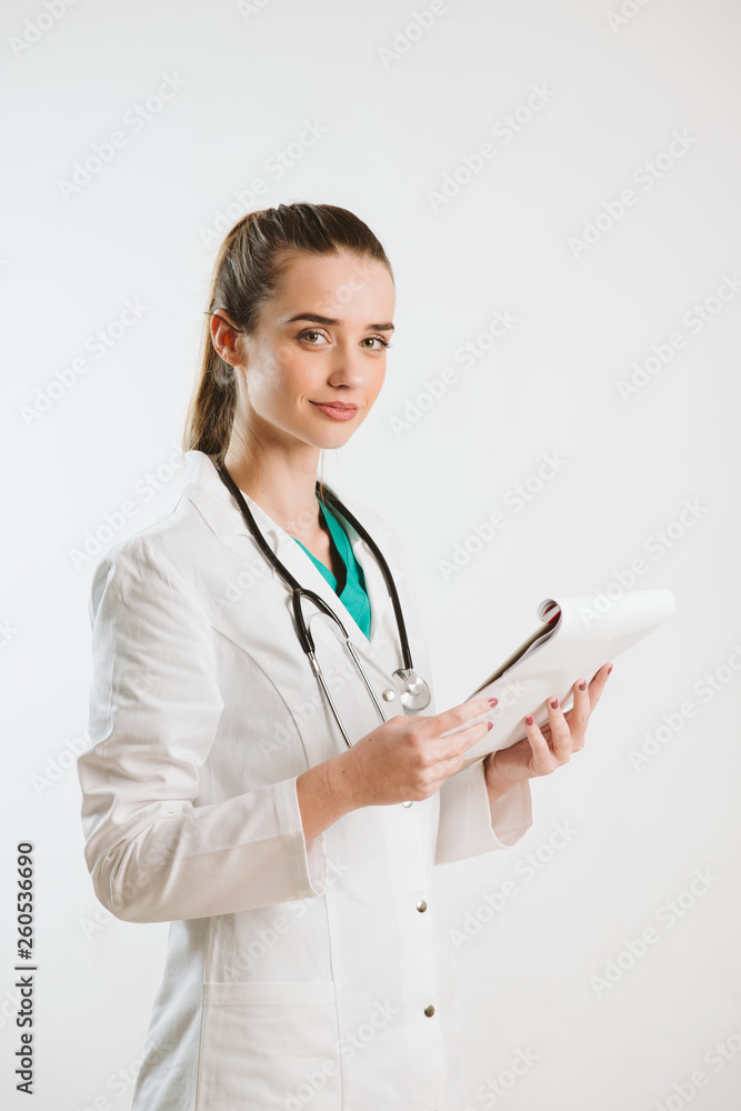 Young nurse with stethoscope and papers in her scrub uniform. Young nurse with stethoscope and papers in her scrub uniform.