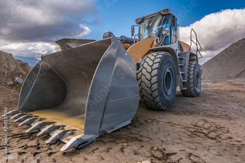Bulldozer type excavator working in a rock and stone processing plant for gravel processing