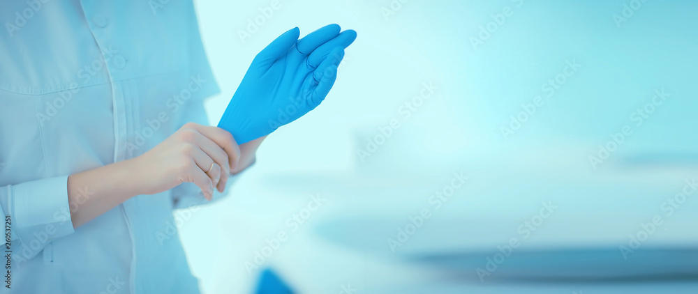 doctor in rubber gloves / concept sterility purity, medical clinic, laboratory, gloves on the hands of a doctor doctor in rubber gloves / concept sterility purity, medical clinic, laboratory, gloves on the hands of a doctor