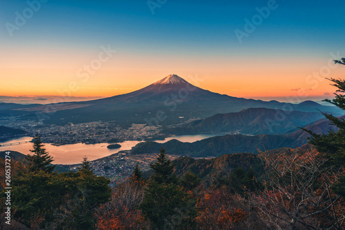 Landscape image of Mt. Fuji over Lake Kawaguchiko with autumn foliage at sunrise in Fujikawaguchiko, Japan.