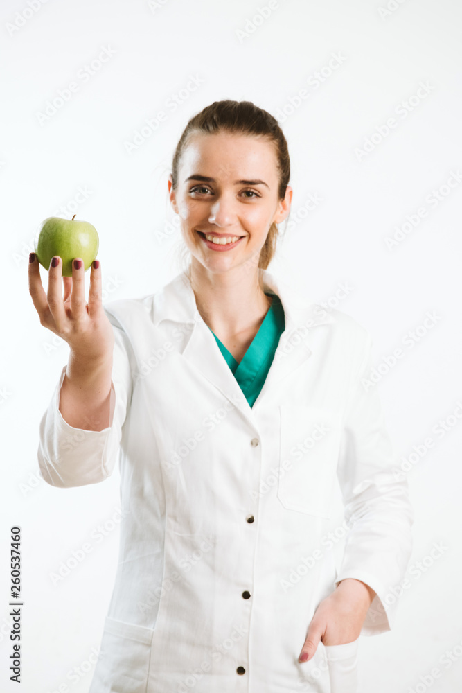 Young nurse holding an apple, a healthy snack. Young nurse holding an apple, a healthy snack.