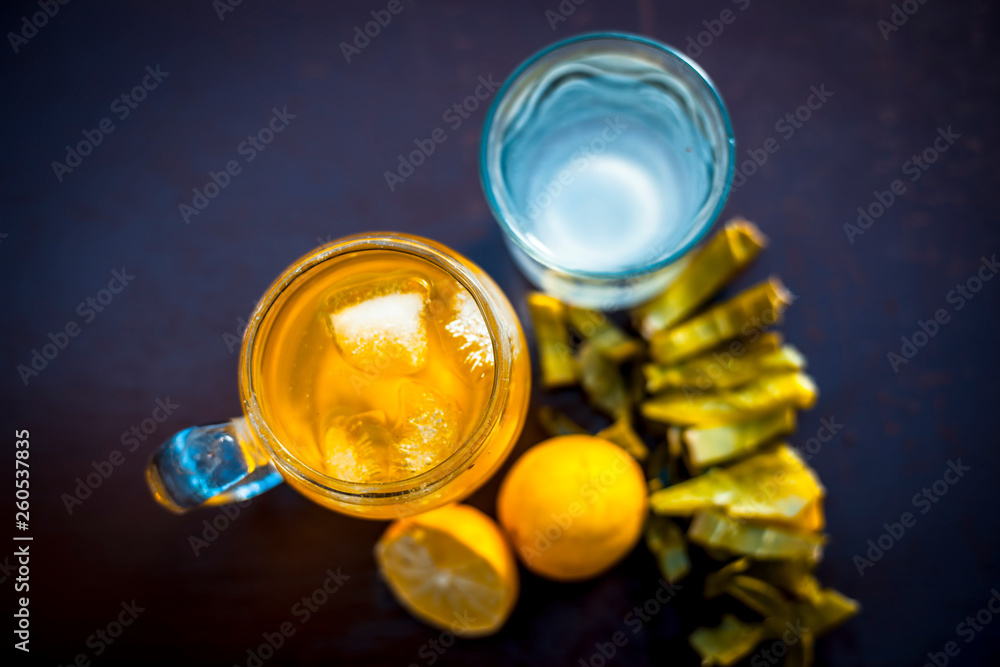 Herbal detoxifying aloe vera iced tea in a big transparent glass with entire ingredients which are orange & lemon juice,tea leaves powder,coconut water and honey and aloe vera gel. Herbal detoxifying aloe vera iced tea in a big transparent glass with entire ingredients which are orange & lemon juice,tea leaves powder,coconut water and honey and aloe vera gel.